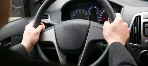 Driver's hands on a car steering wheel — power steering service by The Power Steering Shop NZ