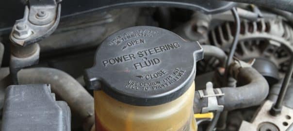 Power steering fluid container inside the engine bay.